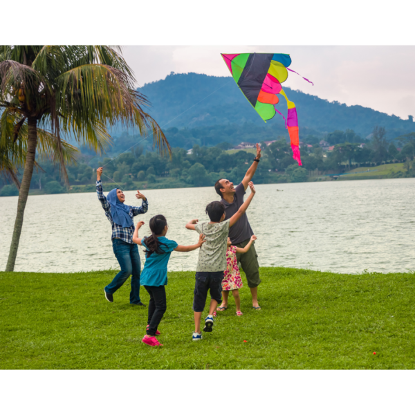 A family at a beach flying a kite shows how to do various activities that are fun and full of learning.