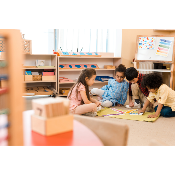 Four kids playing with color tiles in a Montessori Homeschool