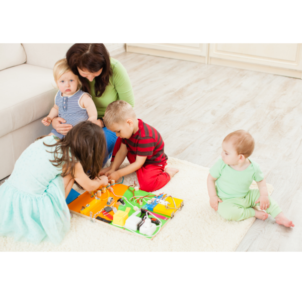 Mother with four children playing on a busy board in a Montessori Homeschool