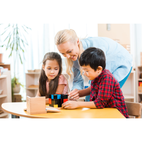 Woman stacking color blocks with a boy and a girl in a Montessori Homeschool