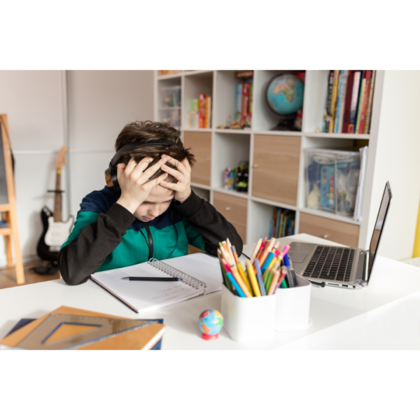 Boy with headphones frustrated with writing in his homeschool curriculum